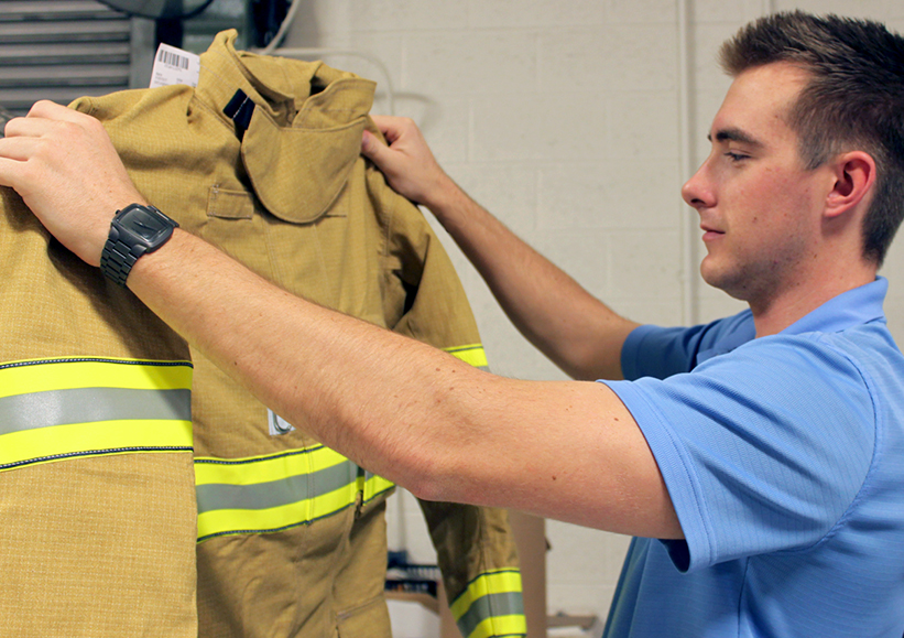 Inspecting firefighting Turnout coat