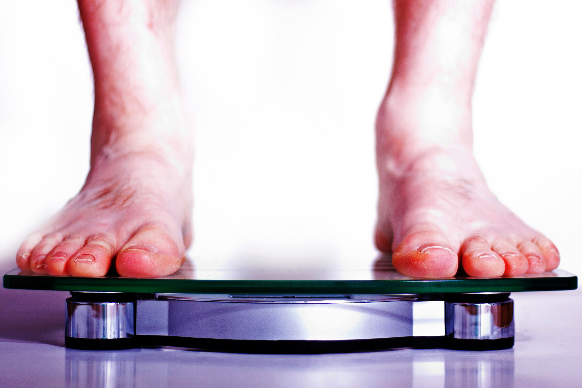 Feet standing on a bathroom scale